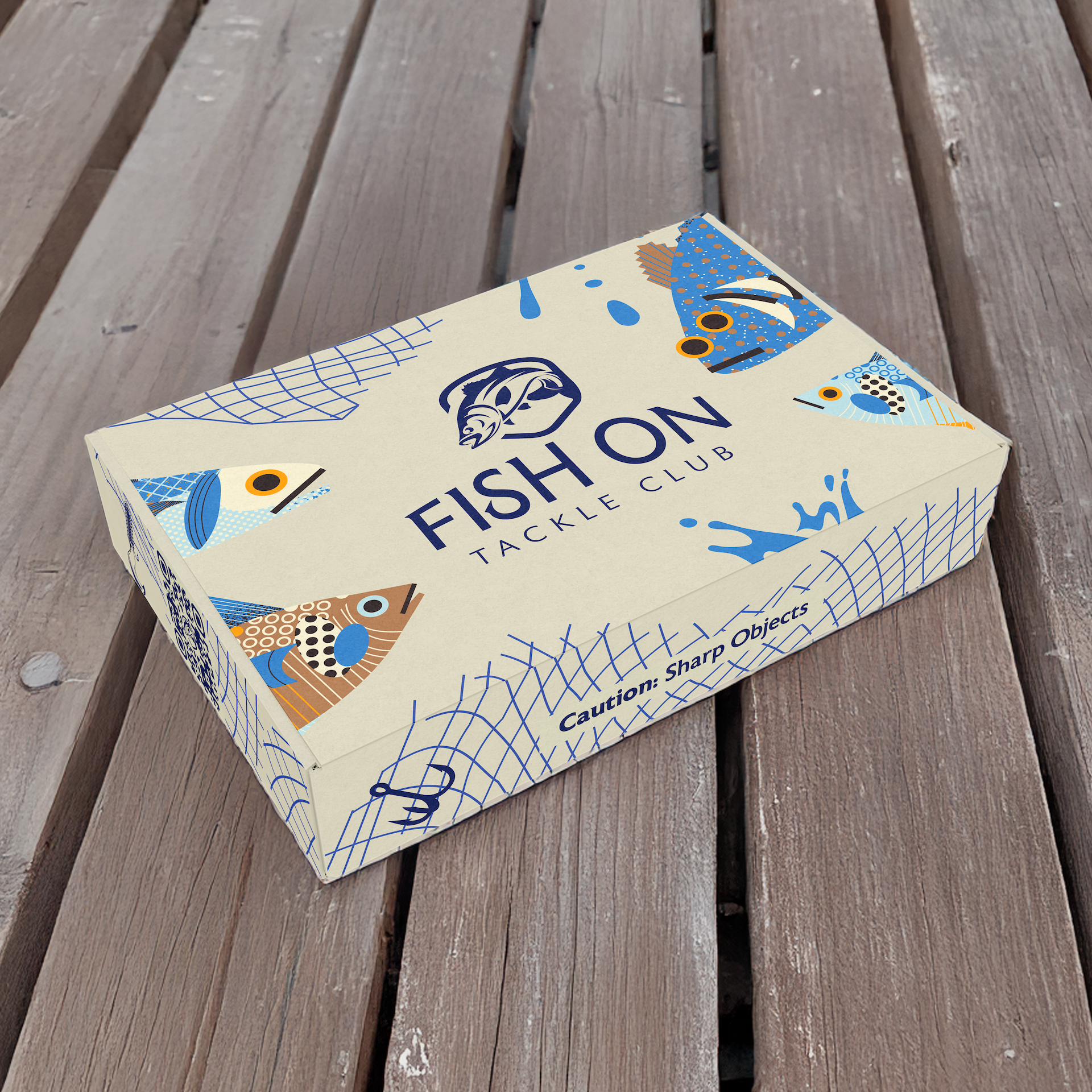Fish On Tackle Club subscription box on a deck